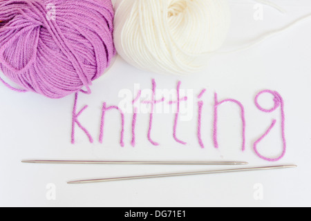 "Stricknadeln" Text Wort Handwerk Hobby Hintergrund Skein Knäuel stricken Garn Rollen lila weiß Stockfoto