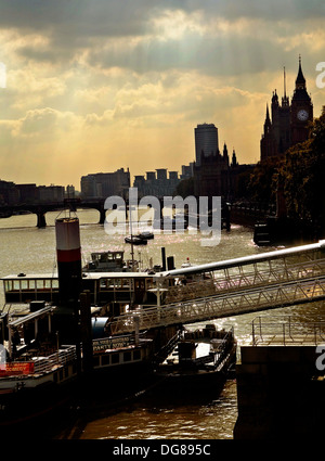 Restaurant-Raddampfer Boot auf der Themse mit Westminster im Hintergrund Sonnenuntergang durch Regenwolken in der Abenddämmerung Stockfoto