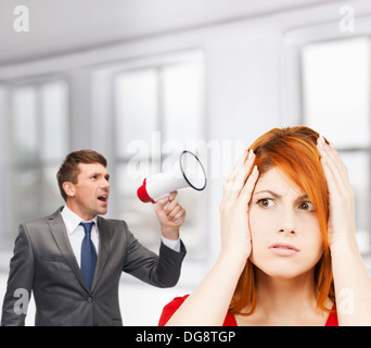 Buisnessman mit Megaphon und gestresste Frau Stockfoto