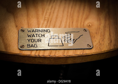 Beutel Diebe - ein Zeichen, das auf einem Tisch Warnung der bag Diebe behoben. Stockfoto