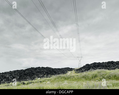 Haufen Sie Alter Reifen unter Pylon im Feld Stockfoto