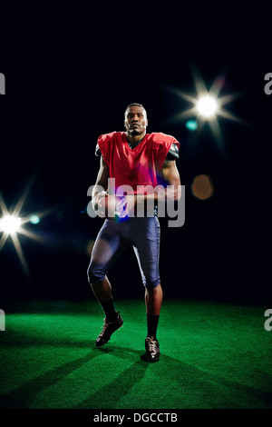 US-amerikanischer American-Football-Spieler halten ball Stockfoto