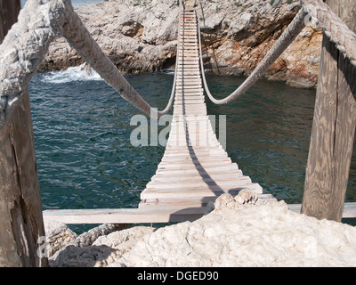 hängende Holzbrücke verbinden felsigen Meer-Kosten Stockfoto