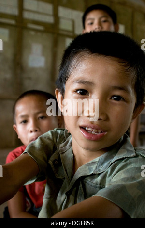 Drei junge Burschen sind in seiner Klasse an der Grundschule Ban Bumlao in Ban Bumlao, der Provinz Luang Prabang, Laos gesammelt. Stockfoto