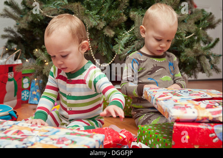 Bruder und Schwester Blick auf Weihnachtsgeschenke Stockfoto