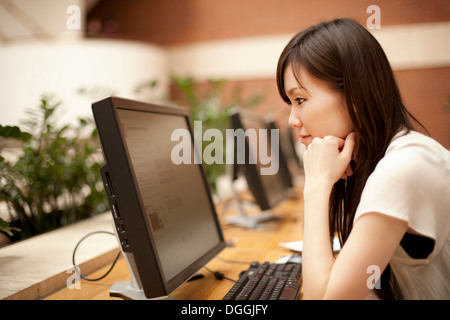 Mitte erwachsenen Frau Computermonitor betrachten Stockfoto