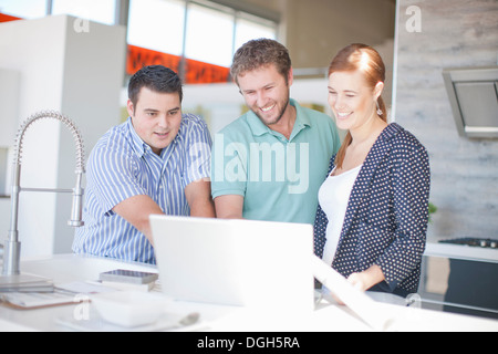 Junges Paar mit Verkäufer in Küche showroom Stockfoto