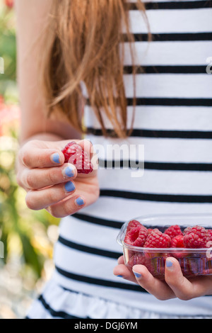 Frau Holding Himbeeren. Stockfoto