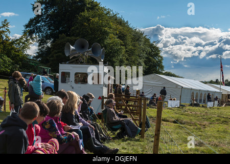 Massen von Menschen sitzen beobachten Sheepdog Trials und Kommentator Derbyshire England anhören Stockfoto