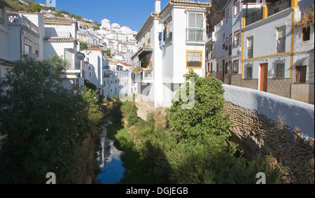 Fluss, vorbei an weiß getünchten Häusern Setenil de Las Bodegas, Provinz Cadiz, Spanien Stockfoto