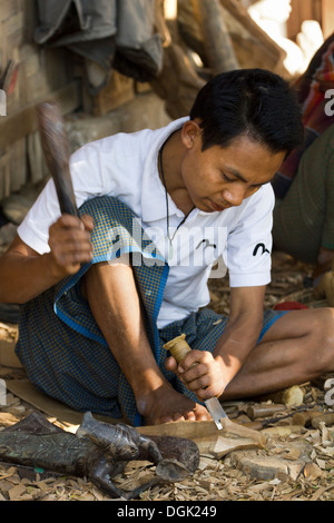 Ein Mann schnitzen burmesische Marionetten in Mandalay in Myanmar. Stockfoto