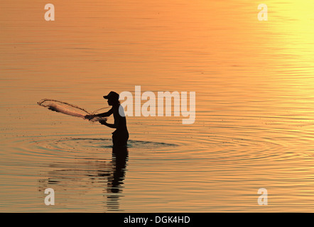 Ein Fischer auf Taungthaman See in Myanmar bei Sonnenuntergang. Stockfoto