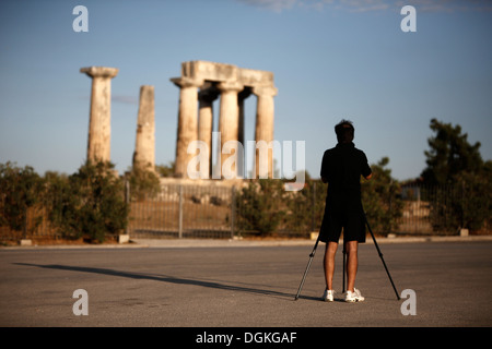 Touristen fotografieren den Apollo-Tempel im antiken Korinth, Griechenland. Stockfoto