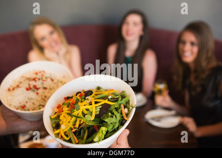 Kellner bringt den Salat Stockfoto