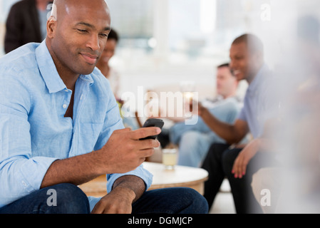 Büro Event. Ein Mann mit seinem Smartphone. Stockfoto