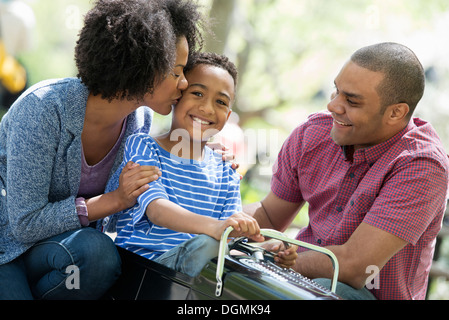 Ein Junge Reiten eine altmodische Spielzeug hausieren Auto. Stockfoto