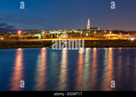 Lichter von Reykjavík spiegelt sich in der Stadt Lake Tjoernin, Island, Europa Stockfoto