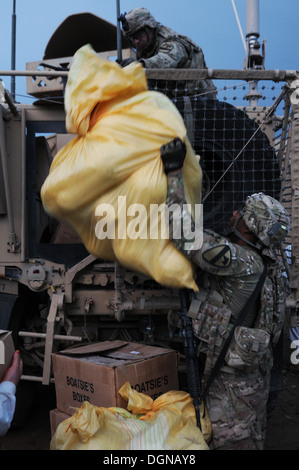 PARWAN Provinz, Afghanistan – Soldaten mit 3. Bataillon "Red Dragon", Fort Hood, Texas, 82. Feldartillerie-Regiment, 2. "Black Jack" Brigade Combat Team, 1. Kavallerie-Division entladen Spendengüter gegeben für die Bewohner der Qal'eh-ye Nasro, Afghani Stockfoto