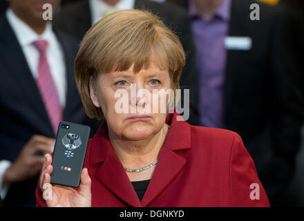 Hannover, Deutschland. 5. März 2013. Bundeskanzlerin Angela Merkel präsentiert eine abhörsichere Handy BlackBerry an einem Stand von Secusmart während der Eröffnung Runde Tour der weltweit größte Computer-Messe CeBIT in Hannover, Deutschland, 5. März 2013. Merkel erhält ein neues offizielles Handy und Blackberry sowie ein Smartphone von Samsung sind auf den ausgewählten. Foto: JULIAN STRATENSCHULTE/Dpa/Alamy Live News Stockfoto