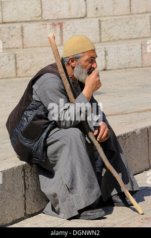 Palästinensischer Mann sitzen auf den Stufen vor dem Damaskus-Tor vor der alten Stadt, Jerusalem, Israel, Nahost Stockfoto