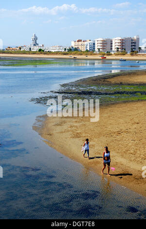 Menschen zu Fuß den Strand, Leuchtturm in den Rücken, Isla Cristina, Costa De La Luz, Region Huelva, Andalusien, Spanien, Europa Stockfoto