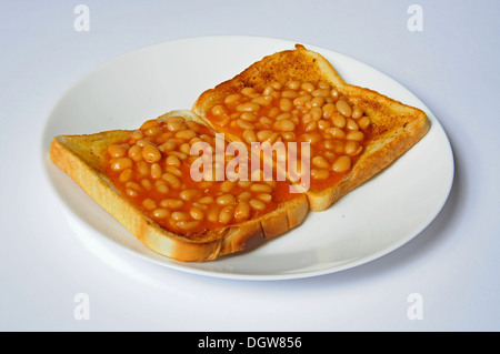 Zwei Runden Bohnen auf Toast auf einem weißen Teller. Stockfoto