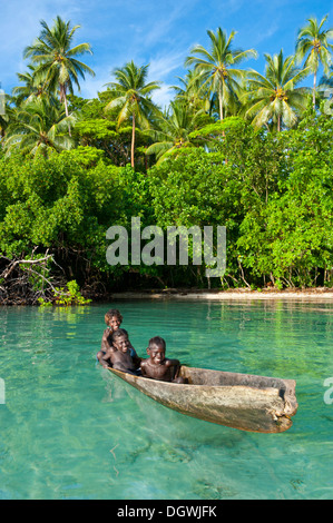 Lokalen Jungs mit dem Kanu in die Marovo Lagune, Marovo Lagune, Western Province, Salomonen Stockfoto