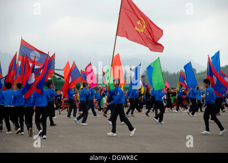 Festival, junge Männer der Jugend Lao Youth, laotische Nationalflaggen, Fahnen der kommunistischen Partei, Muang Xai group Stockfoto