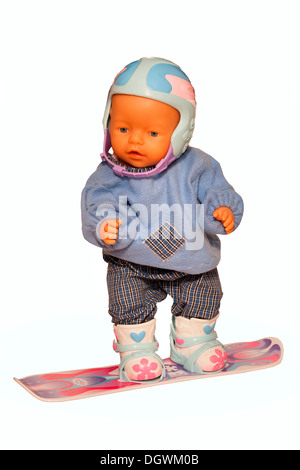 Baby-Puppe mit Ski-Kleidung auf einem snowboard Stockfoto