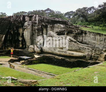 Liegender Buddha, Eingang ins Nirwana, ein Tourist steht man vor der Felsentempel Gal Vihara, UNESCO-Weltkulturerbe Stockfoto