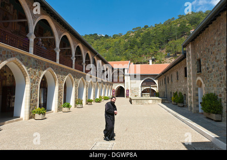 Griechische orthodoxe Kirche von Zypern, schwarz gekleideten Mönch im Hof des Klosters, Kykkos-Kloster, Troodos-Gebirge Stockfoto