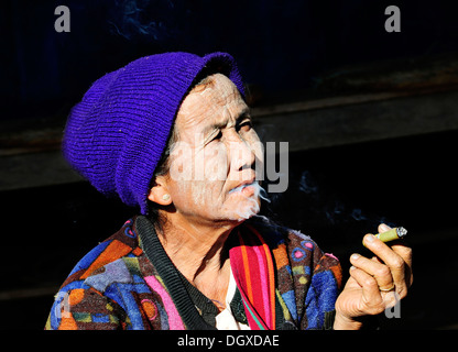 Ältere Frau mit Thanaka Paste im Gesicht trägt einen Hut und eine Zigarre rauchend, Myanmar, Birma, Südostasien, Asien Stockfoto