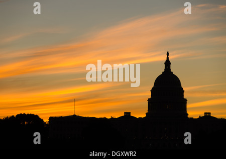 WASHINGTON DC, USA – die Sonne geht hinter einer Silhouette der Kuppel des US Capitol Building (Congress) in Washington DC auf und beleuchtet die Lichtwolken. Stockfoto