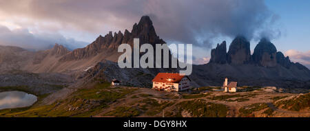 Panorama mit Dreizinnenhuette Hütte und Kapelle, Blick auf Mt Paternkofel und die Tre Cime di Lavaredo im Morgengrauen Stockfoto