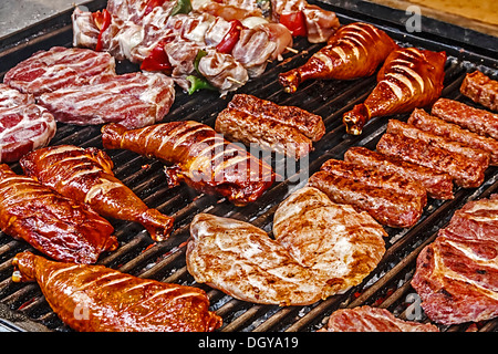 Rumänische Wurst (Mici), Schweinefleisch, Hühnerfleisch und gebratene Spieße auf den Grill gelegt. Stockfoto