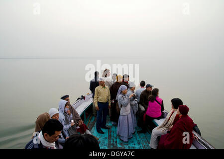 Buddhistische Nonnen und Gläubige aus Vietnam, Frankreich, USA, Großbritannien und Kanada auf einem Schiff auf dem Ganges in der Morgendämmerung, Varanasi Stockfoto