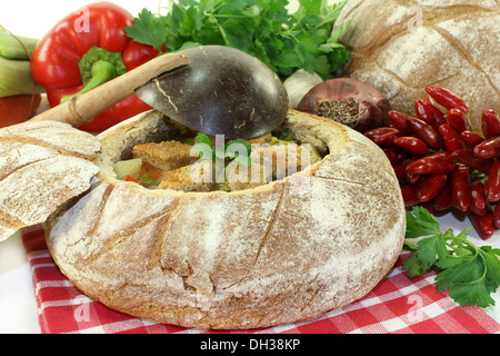 ein Bauernbrot gefüllt mit einer bunten Brotsuppe Stockfoto