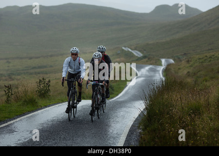 Drei Radfahrer einen nassen Pfad in die schottischen Highlands, Schottland, Vereinigtes Königreich Stockfoto