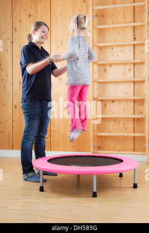 Mädchen Training springen auf einem Trampolin Stockfoto