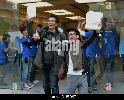 Tokio, Japan. 1. November 2013. Japanische Apple-Liebhaber zeigen Boxen des iPad Air triumphierend, sobald sie aus dem Apple Store in Tokios Einkaufsviertel Ginza auf Freitag, 1. November 2013 entstehen. Das iPad Air, Apples neue dünnere und leichtere Version seines Tablet-Computers und eine verbesserte Version seiner kleineren iPad Mini ging auf Verkauf im ganzen Land in Apple Stores und Outlets der japanischen Mobilfunk-Carrier. Bildnachweis: Natsuki Sakai/AFLO/Alamy Live-Nachrichten Stockfoto