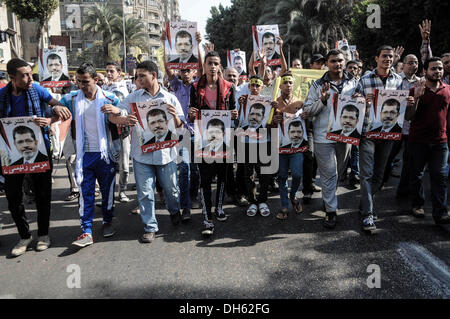 Kairo, Ägypten. 1. November 2013. Unterstützer von Ägyptens Präsident Mohammed Morsi halten verdrängt sein Plakat wie sie ihre Hände mit vier Fingern, die ein Symbol der Rabaah al-Adawiya Moschee erheben, wo Mursi-Anhänger ein Sit-in für Wochen im August statt, aber wurde gewaltsam zerstreut später, während einer Protestaktion in Kairo, Ägypten Mohandsin, Freitag, 1 November, 2013.Photo geworden: Nameer Gala/NurPhoto Credit: Nameer Mohamed/NurPhoto/ZUMAPRESS.com/Alamy Live News Stockfoto