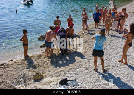 Rettung einer verletzten Unechten Karettschildkröte (Caretta Caretta) auf Jerusalem Beach, in der Nähe von Fiscardo, Kefalonia, Griechenland Stockfoto