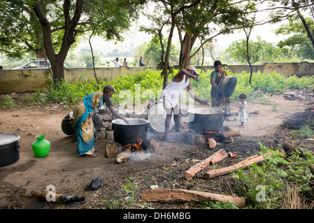 Inder Schule Kochen auf dem offenen Feuer an einem indischen Dorf High School. Andhra Pradesh, Indien Stockfoto