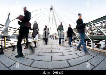 Wanderer verschwommen, wie sie über die Millennium Bridge in London reisen Stockfoto