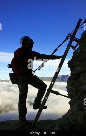 Silhouette der Bergsteiger klettern Metallleiter der Via Ferrata in den Schweizer Alpen, Eiger, Grindelwald, Schweiz Stockfoto