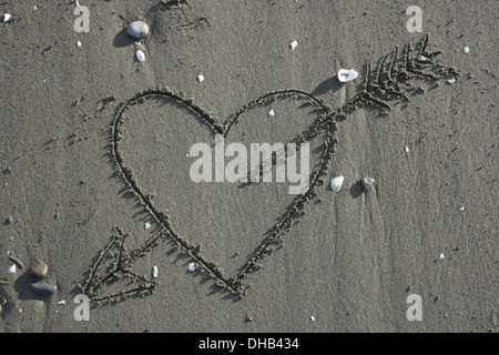 Liebe Herz mit Pfeil gezeichnet im Sand am Strand Stockfoto