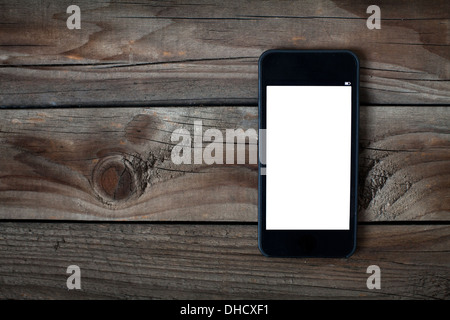 Schwarz Smartphone mit isolierten Bildschirm auf alten Schreibtisch aus Holz Stockfoto