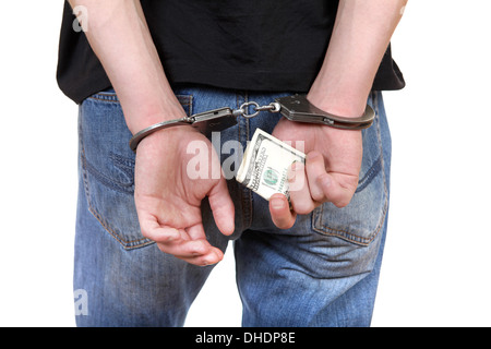 Handschellen in Händen mit Geld Stockfoto