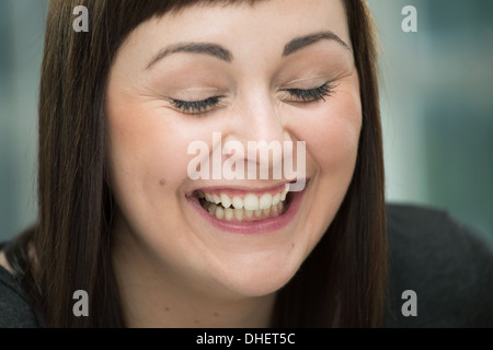 Junge Frau lachen, Augen geschlossen Stockfoto