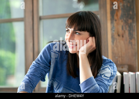 Porträt von Brünette Frau lächelnd mit Hand am Kinn Stockfoto